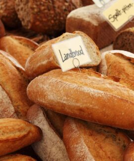 Assorted artisan bread loaves at a bakery, showcasing fresh and rustic textures.