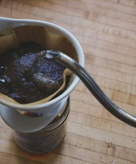 Close-up of freshly brewed pour over coffee on a wooden countertop.