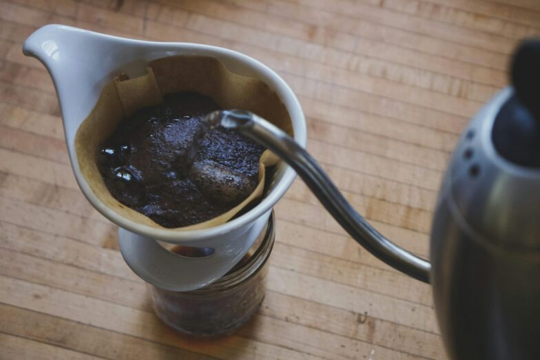 Close-up of freshly brewed pour over coffee on a wooden countertop.