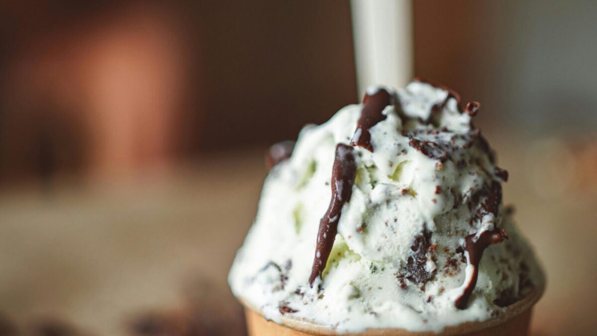 Indulge in a creamy ice cream adorned with rich chocolate drizzle for a decadent treat.