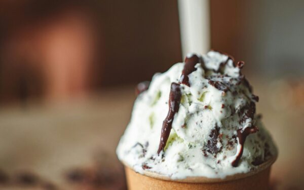 Indulge in a creamy ice cream adorned with rich chocolate drizzle for a decadent treat.