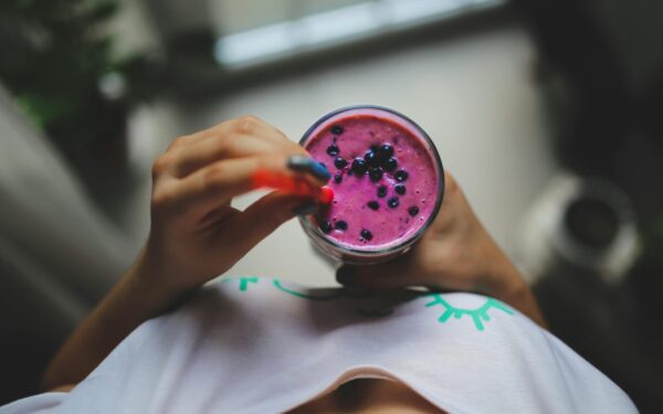 Enjoy a healthy and vibrant blueberry yogurt smoothie with a pop of color, perfect for a nutritious lifestyle.