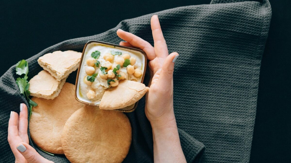 Delicious hummus with chickpeas served with freshly baked pita bread. A healthy Middle Eastern appetizer.