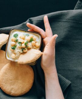 Delicious hummus with chickpeas served with freshly baked pita bread. A healthy Middle Eastern appetizer.