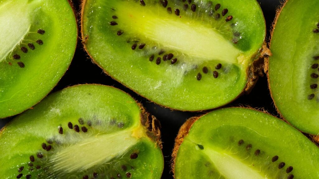 A detailed close-up of juicy kiwi slices showcasing fresh texture and seeds.