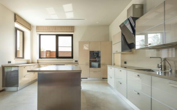 Bright and spacious modern kitchen interior featuring sleek cabinets and a central kitchen island.