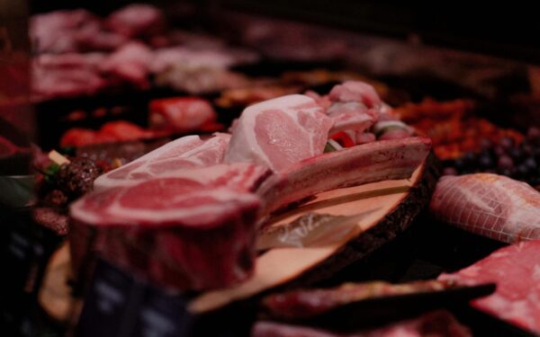 Close-up of a variety of raw meats on display in a market setting, perfect for culinary and food industry themes.