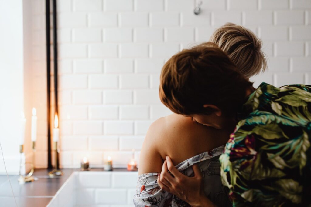 Tender moment between two women expressing love in a cozy indoor setting.