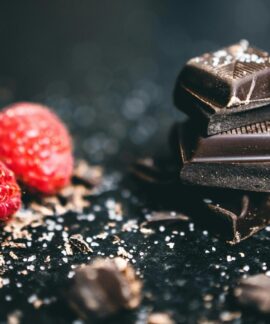 Close-up of dark chocolate pieces and raspberries, perfect for gourmet dessert ideas.