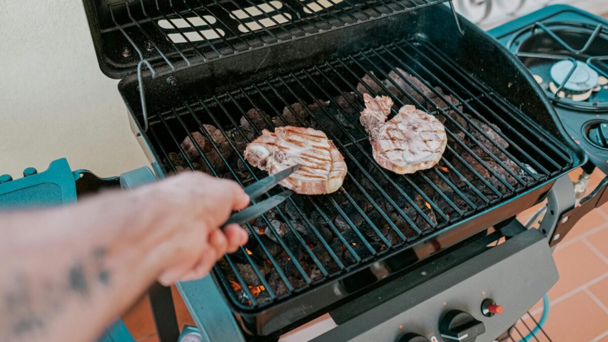 Close-up of two steaks grilled on a barbecue in Sardegna, Italy.