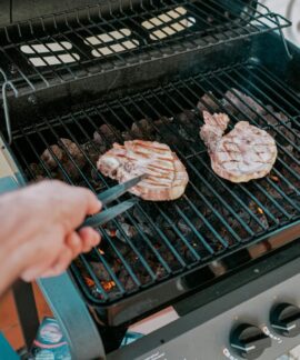 Close-up of two steaks grilled on a barbecue in Sardegna, Italy.