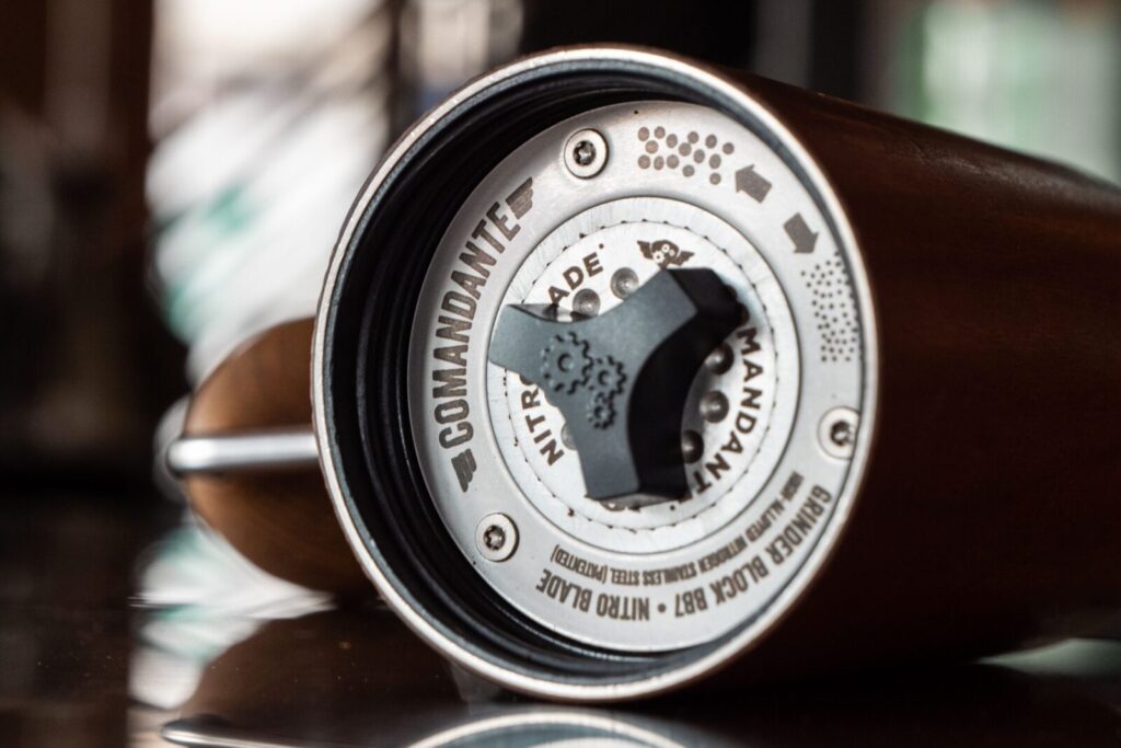 Detailed close-up image of Comandante coffee grinder emphasizing product craftsmanship.