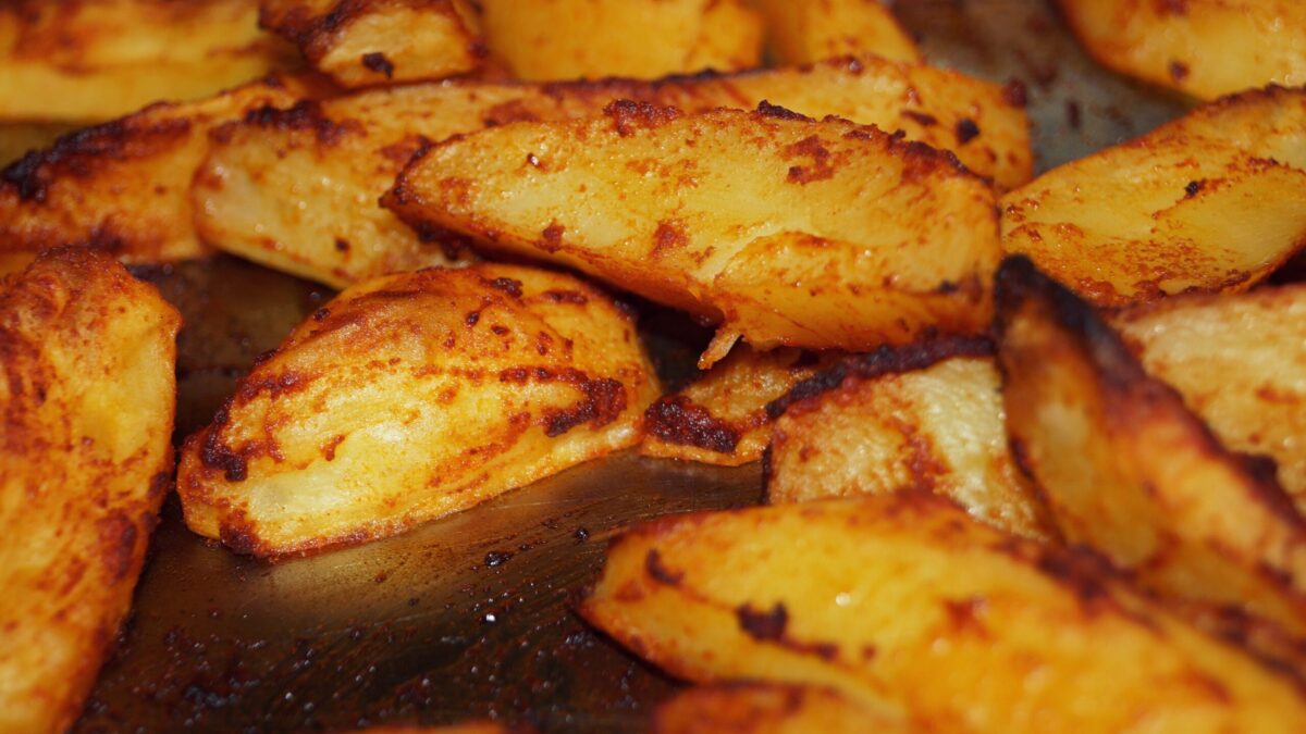 Close-up of homemade roasted potatoes with a golden crispy finish. Perfect for a delicious meal.