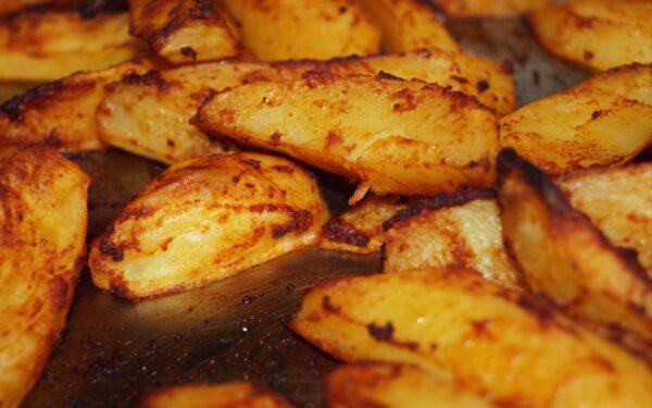 Close-up of homemade roasted potatoes with a golden crispy finish. Perfect for a delicious meal.
