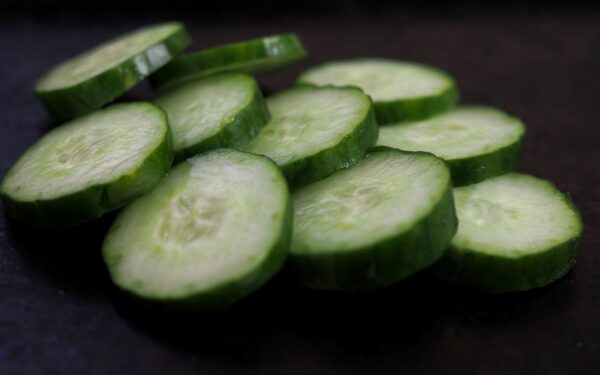 sliced cucumber on brown wooden table