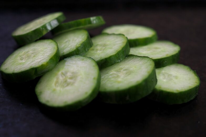 sliced cucumber on brown wooden table