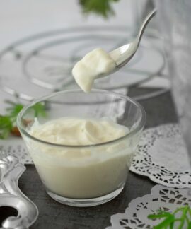 close-up photo of white cream in clear shot glass