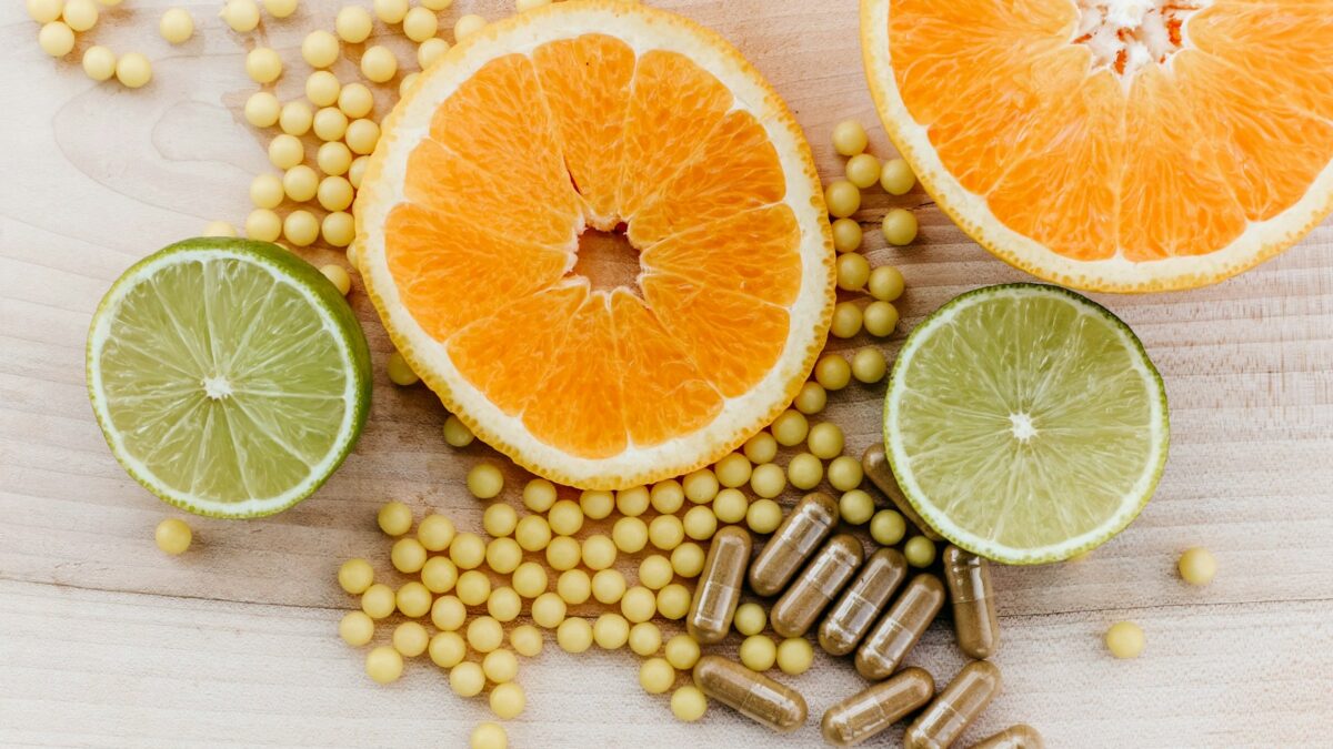 oranges, peas, and limes on a wooden table