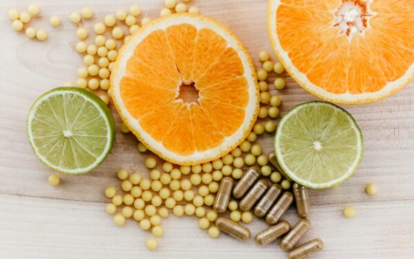oranges, peas, and limes on a wooden table