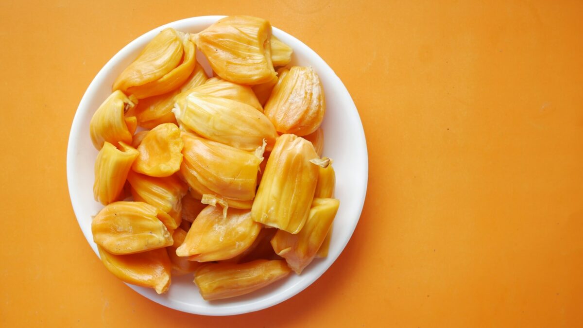sliced yellow fruit in white ceramic bowl