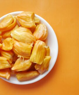 sliced yellow fruit in white ceramic bowl