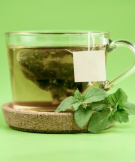 clear glass mug with green leaves