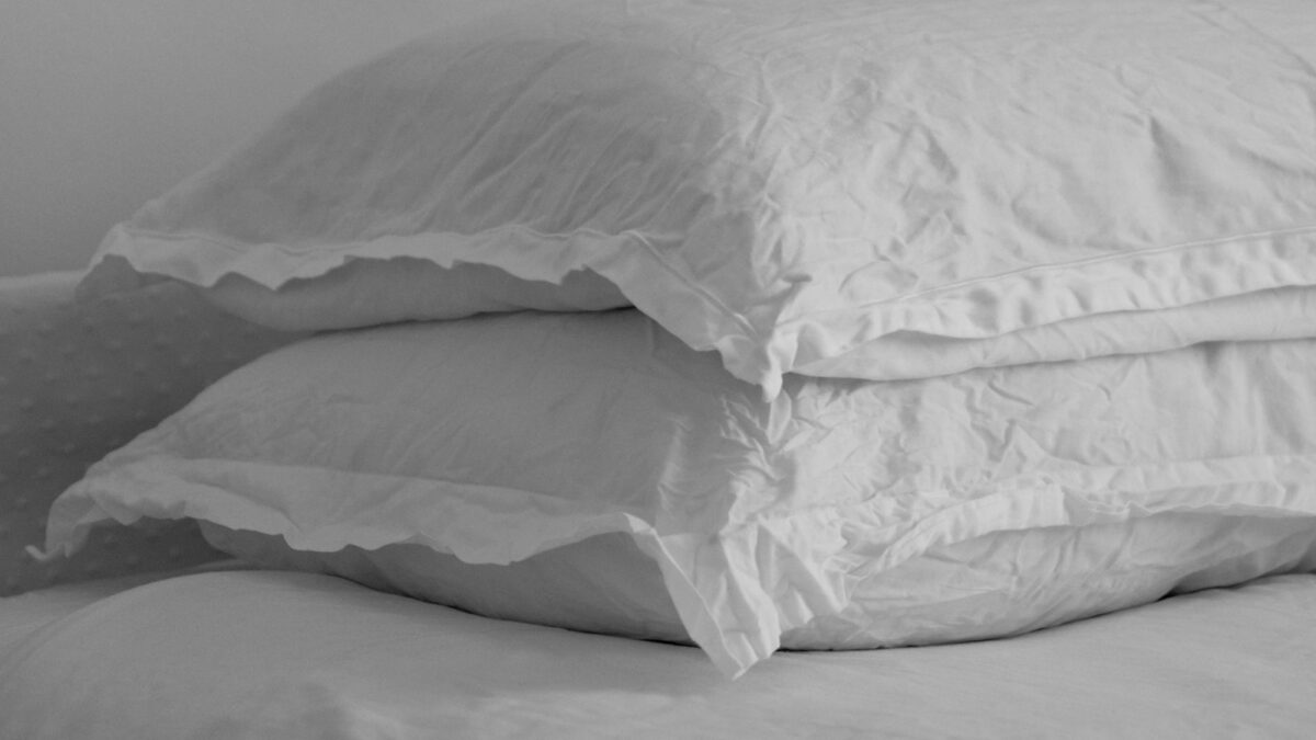 white bed pillow on bed
