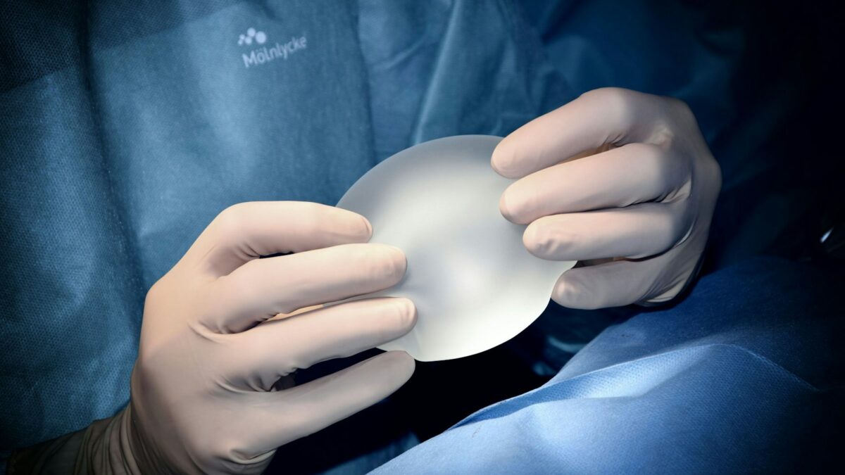 person holding white heart shaped ornament