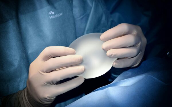 person holding white heart shaped ornament