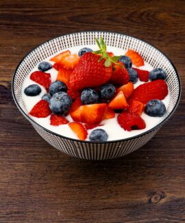 strawberry and blackberries on top of brown table