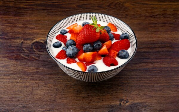 strawberry and blackberries on top of brown table
