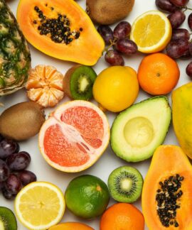 sliced orange fruit and green round fruits