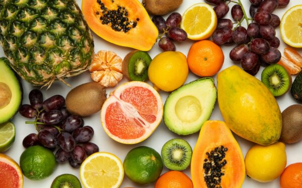 sliced orange fruit and green round fruits