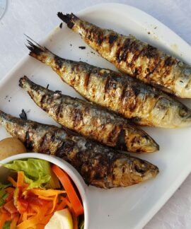 grilled fish with vegetable salad on white ceramic plate