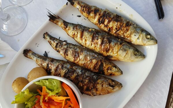 grilled fish with vegetable salad on white ceramic plate