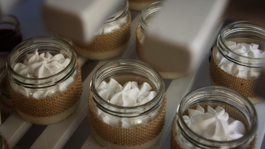 a close up of jars filled with whipped cream