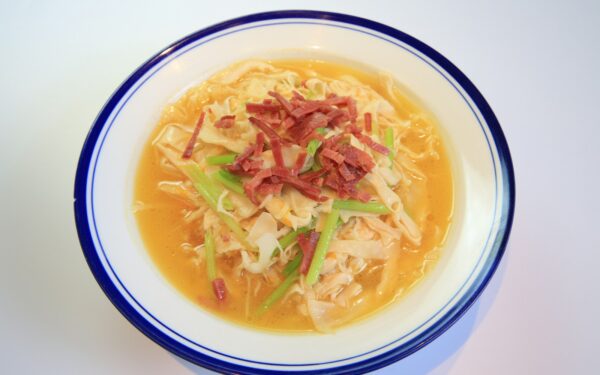 soup in white and blue ceramic bowl