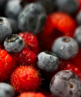 A close up of berries and blueberries in a bowl