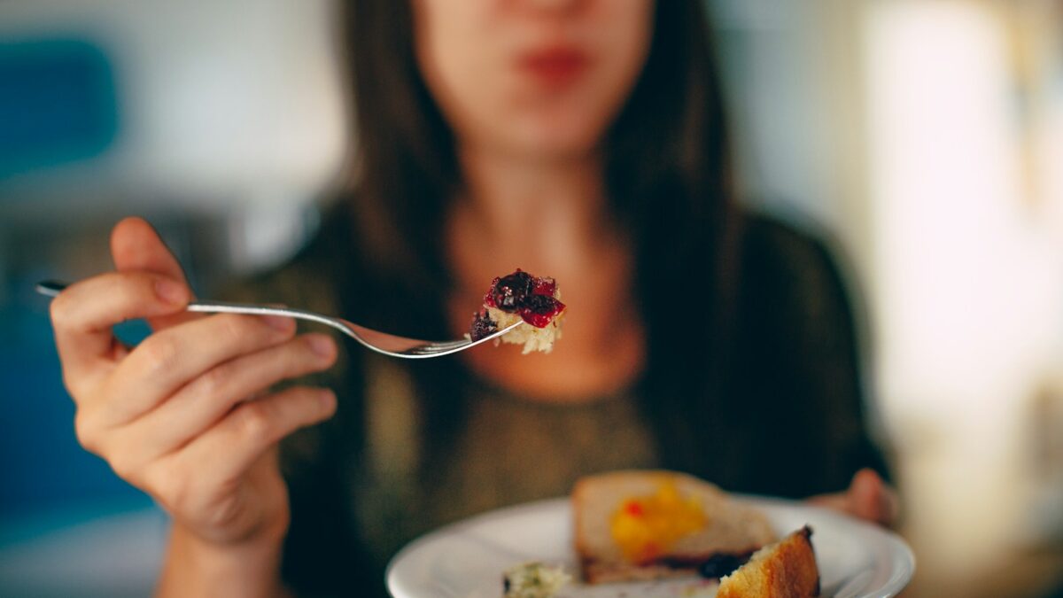 woman holding plate of cake