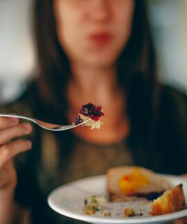 woman holding plate of cake