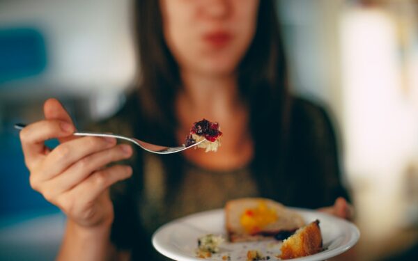 woman holding plate of cake