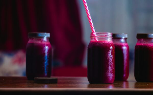 red beverage in mason jars
