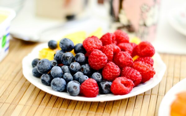 strawberries and blue berries on palte