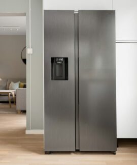 A refrigerator in a kitchen next to a window
