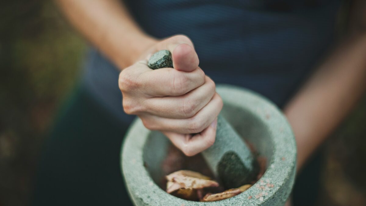 person grinding on mortar and pestle
