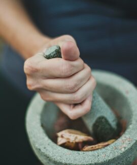 person grinding on mortar and pestle
