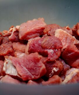raw meat on blue ceramic bowl