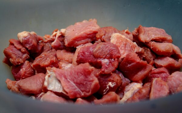 raw meat on blue ceramic bowl