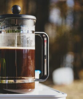 a pitcher of liquid sitting on top of a table