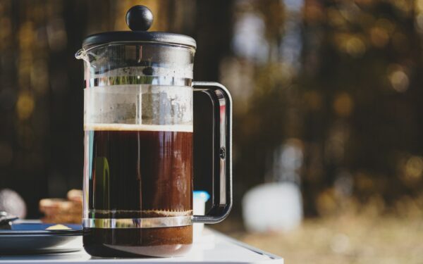 a pitcher of liquid sitting on top of a table